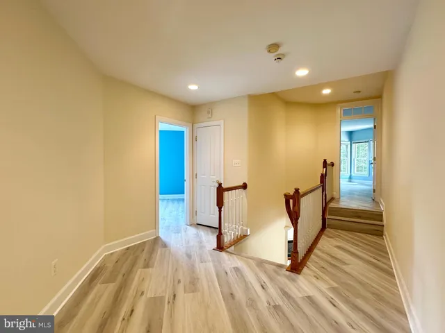 a view of a room with wooden floor and white walls