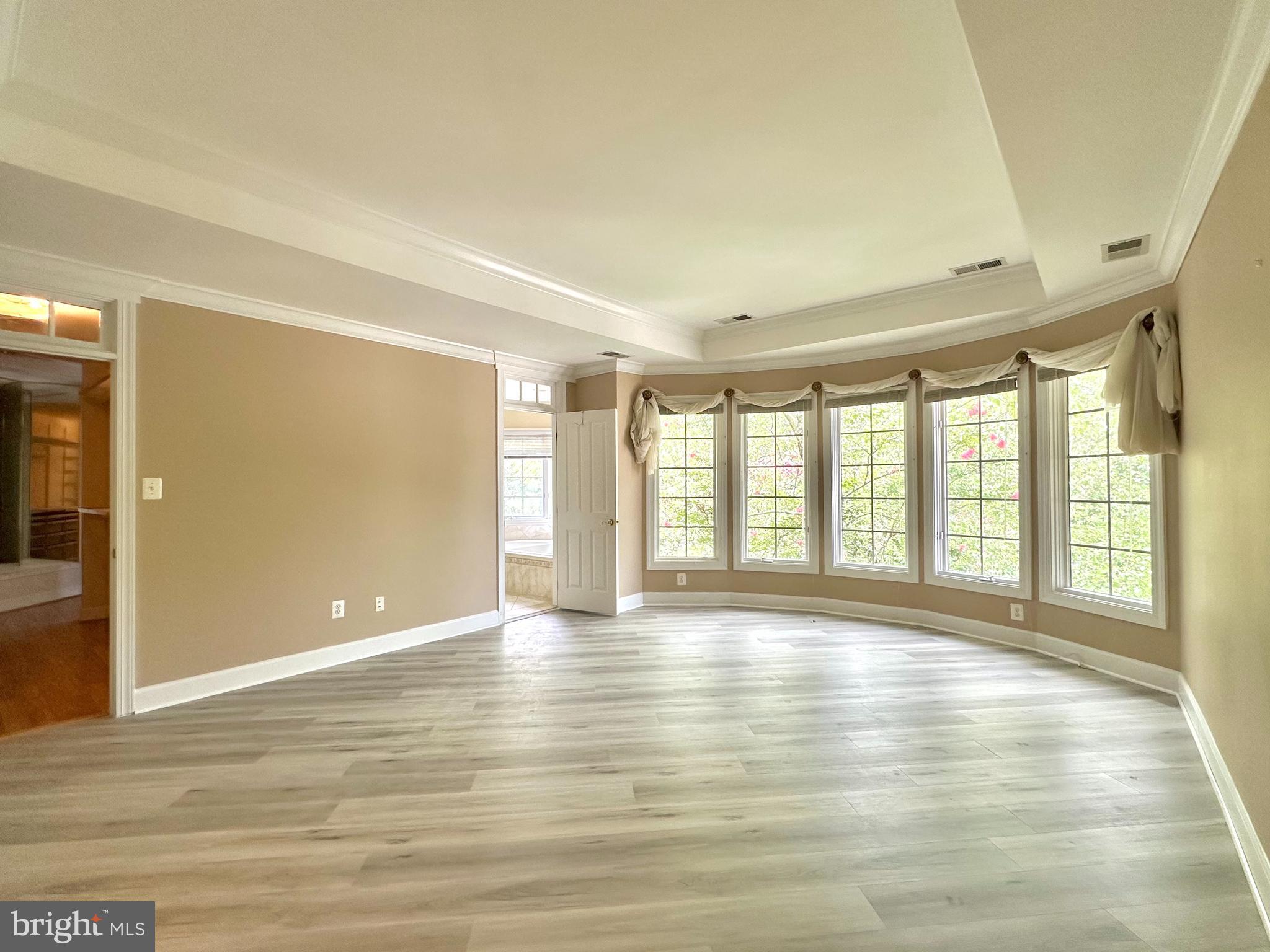 1460 Carrington Ridge Lane Vienna, VA 22182 - Photo 35 of 74 a view of an empty room with wooden floor and a window