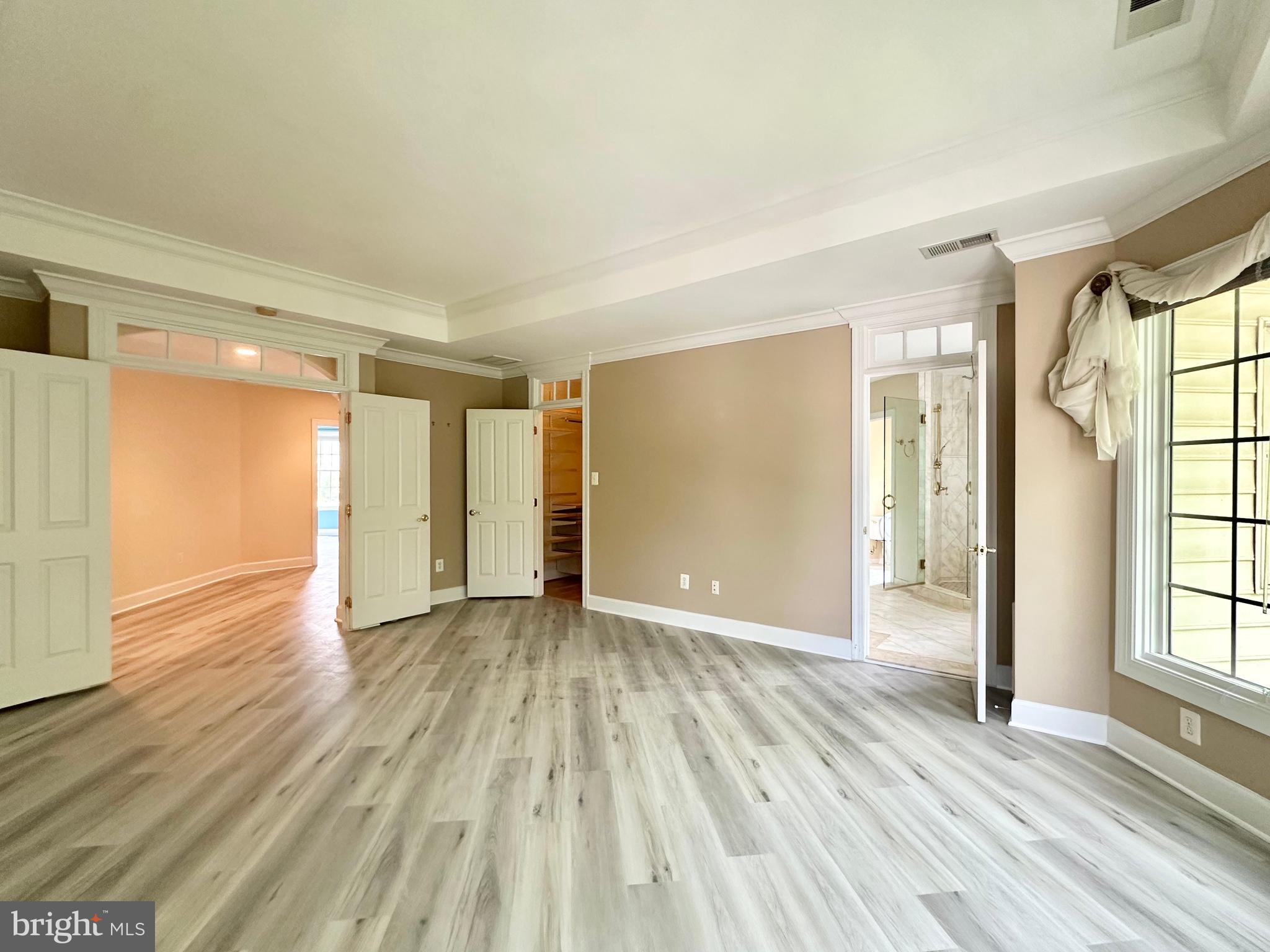1460 Carrington Ridge Lane Vienna, VA 22182 - Photo 37 of 74 a view of an empty room with wooden floor and a window