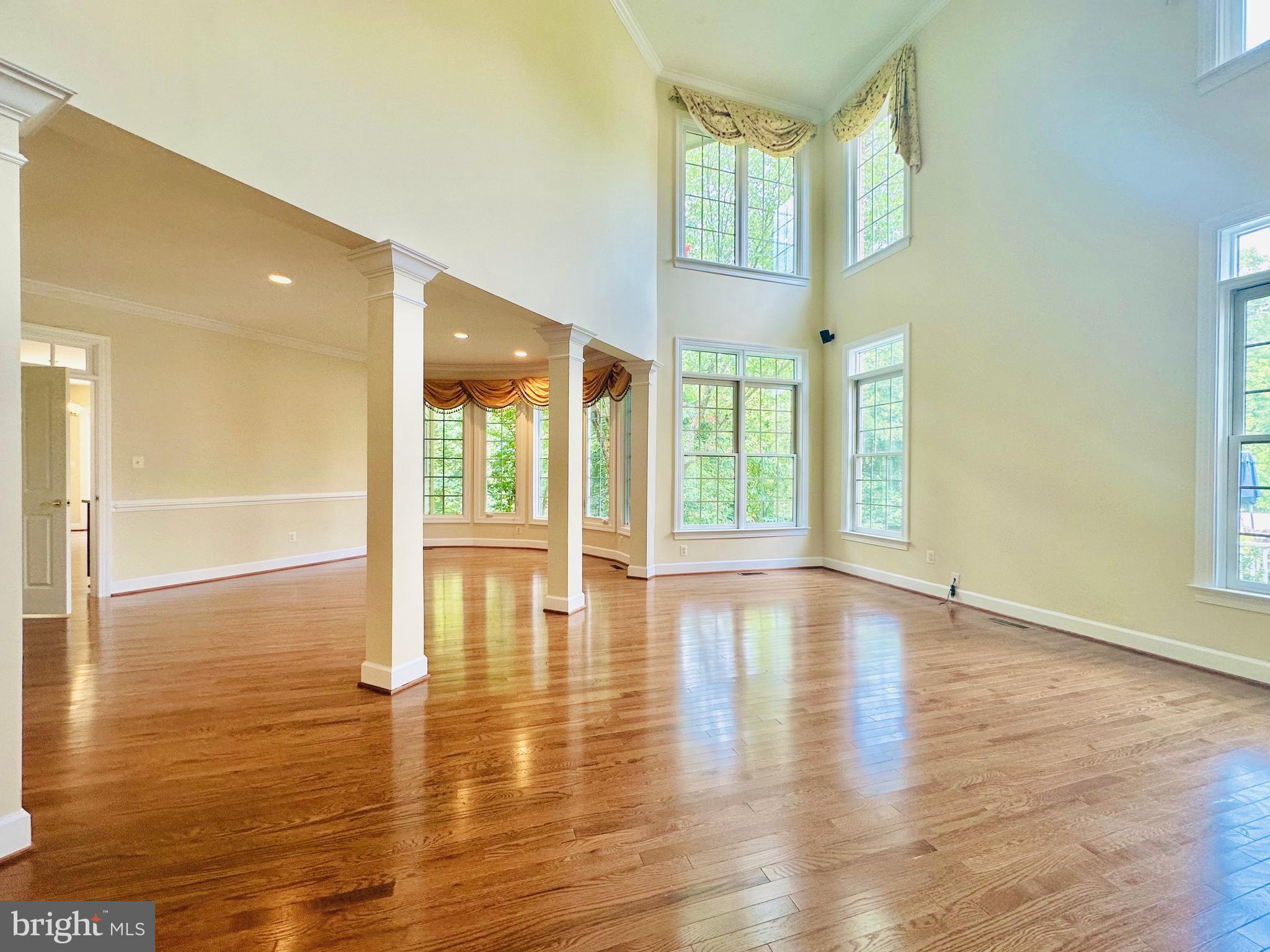 1460 Carrington Ridge Lane Vienna, VA 22182 - Photo 4 of 74 a view of an empty room with wooden floor and a window