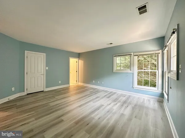a view of a hallway view with wooden floor and staircase