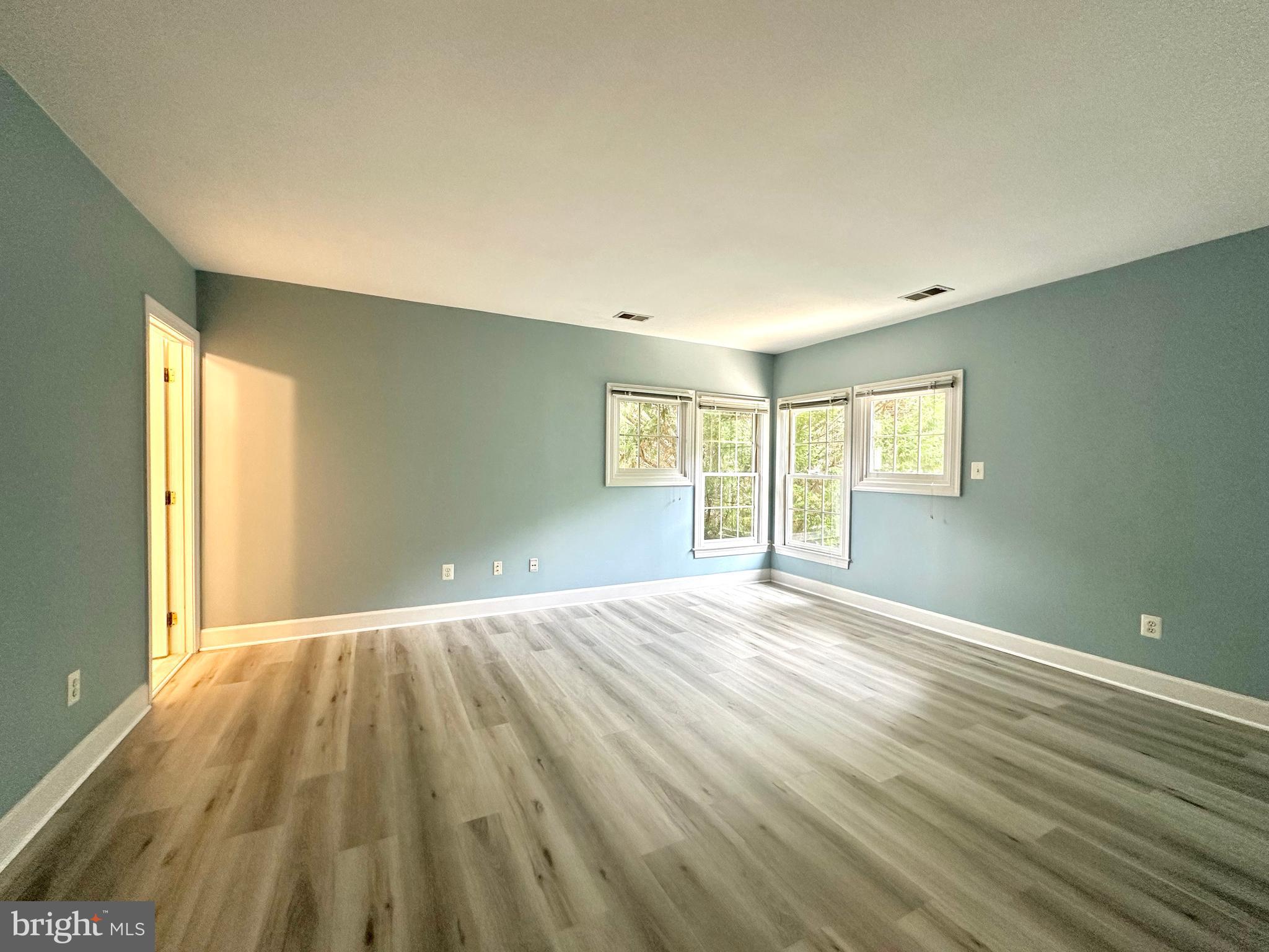 1460 Carrington Ridge Lane Vienna, VA 22182 - Photo 45 of 74 a view of an empty room with wooden floor and a window