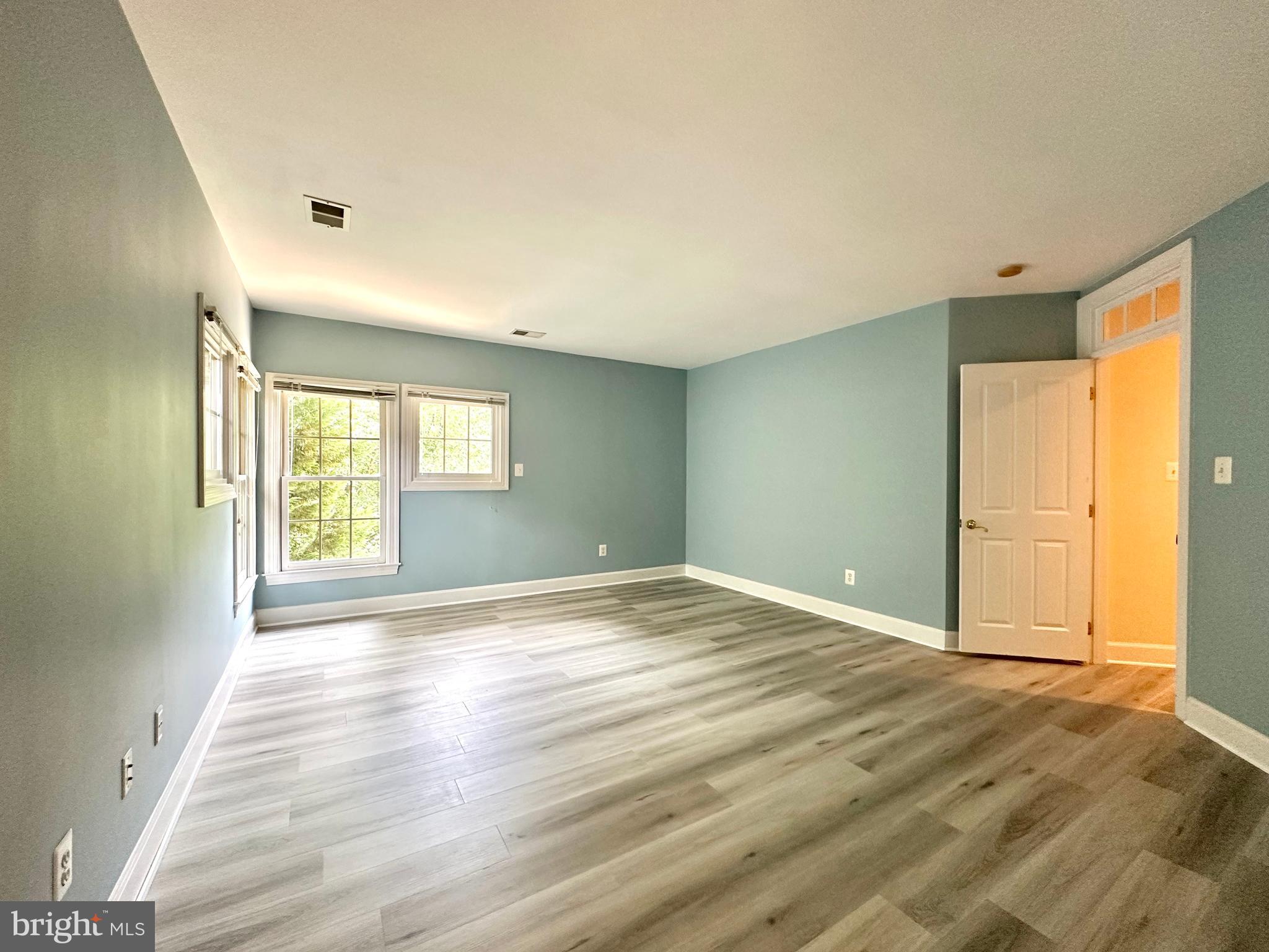 1460 Carrington Ridge Lane Vienna, VA 22182 - Photo 46 of 74 a view of empty room with wooden floor and fan