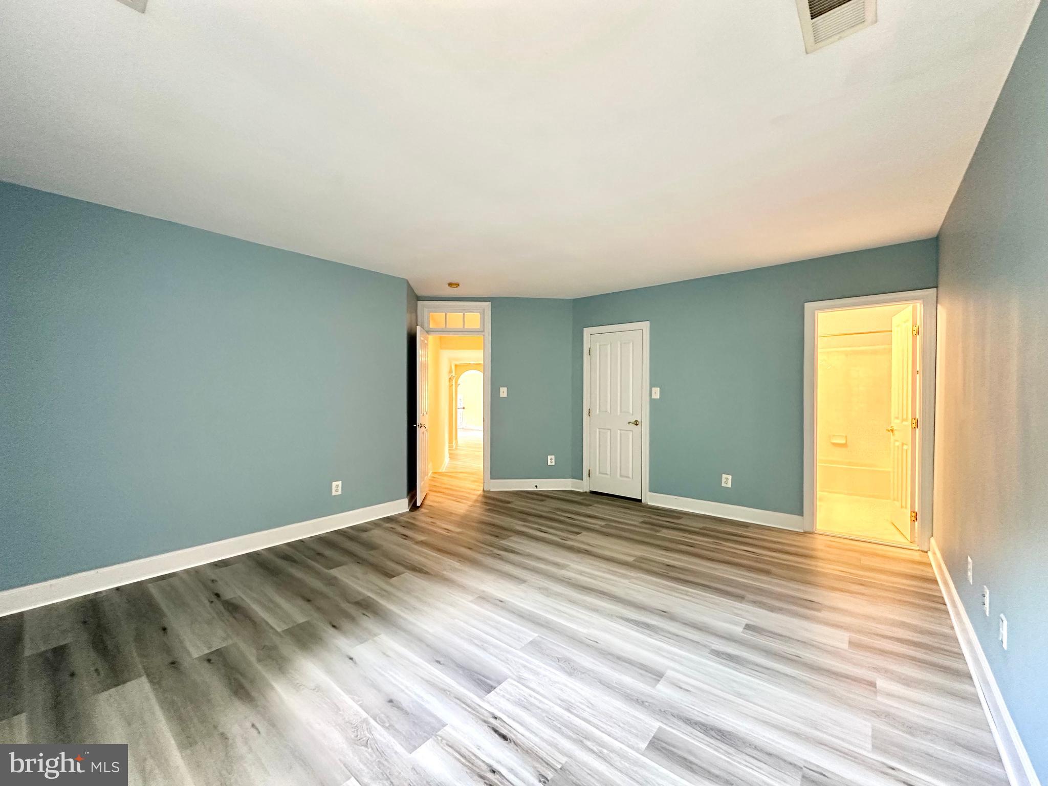 1460 Carrington Ridge Lane Vienna, VA 22182 - Photo 47 of 74 a view of an empty room with wooden floor and a window