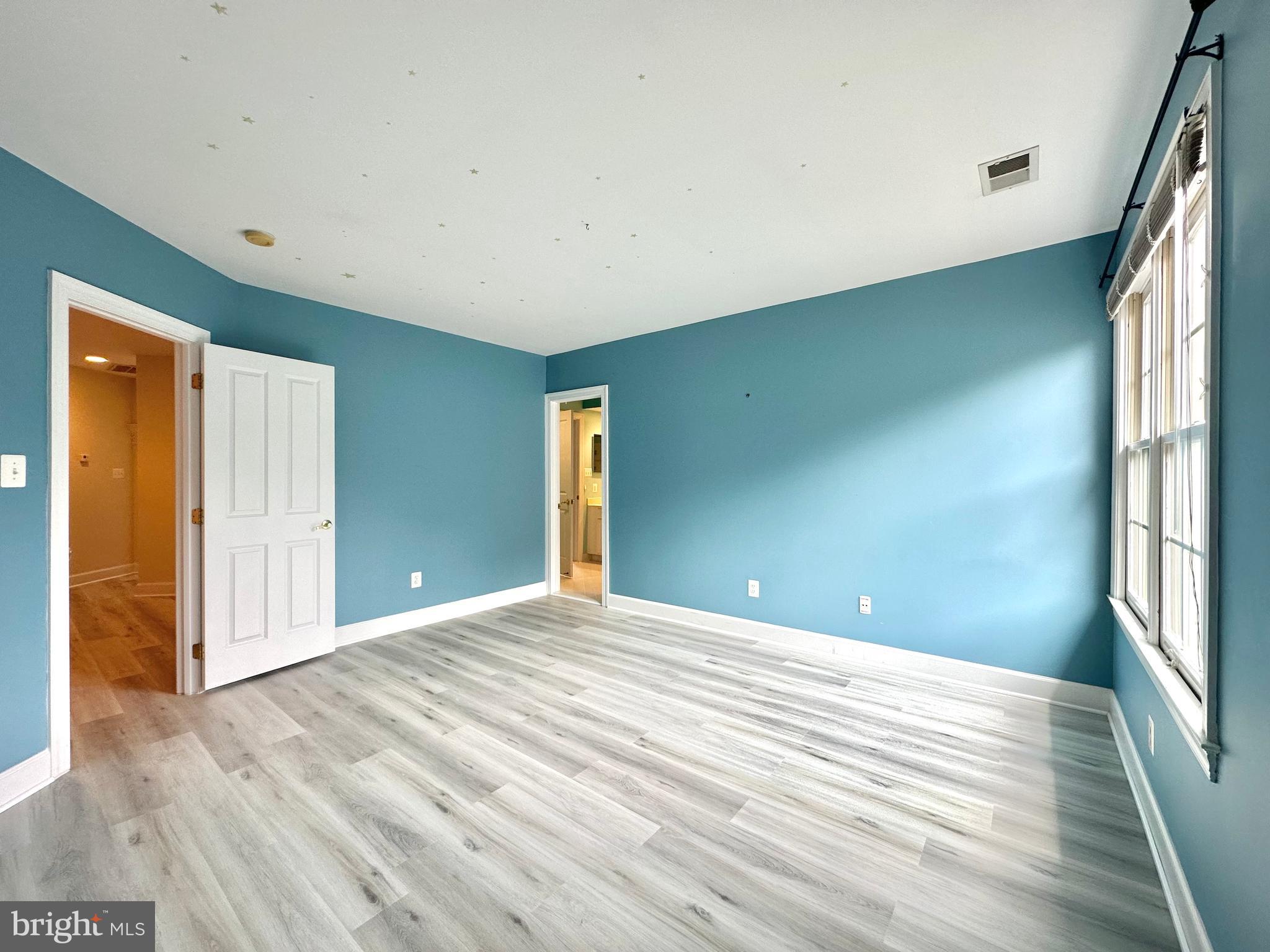 1460 Carrington Ridge Lane Vienna, VA 22182 - Photo 49 of 74 a view of an empty room with wooden floor and a window