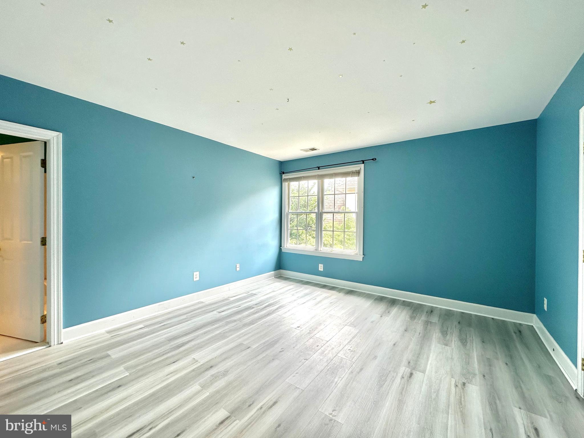 1460 Carrington Ridge Lane Vienna, VA 22182 - Photo 50 of 74 an empty room with wooden floor and windows