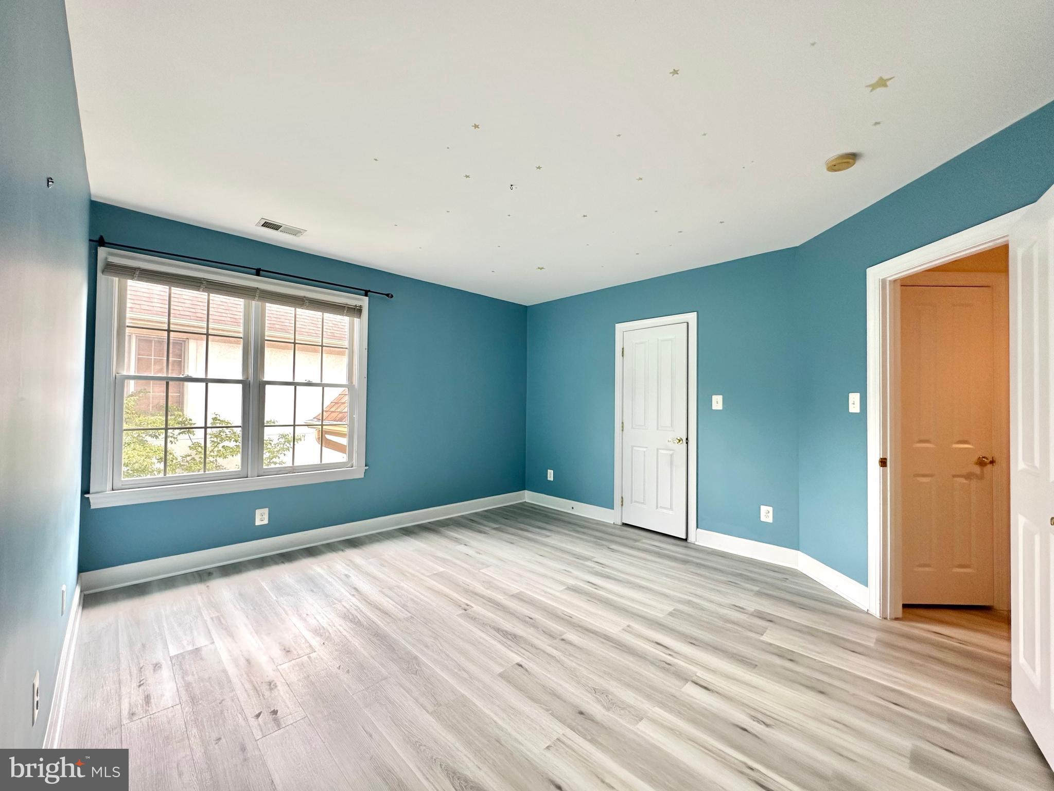 1460 Carrington Ridge Lane Vienna, VA 22182 - Photo 51 of 74 a view of an empty room with wooden floor and a window