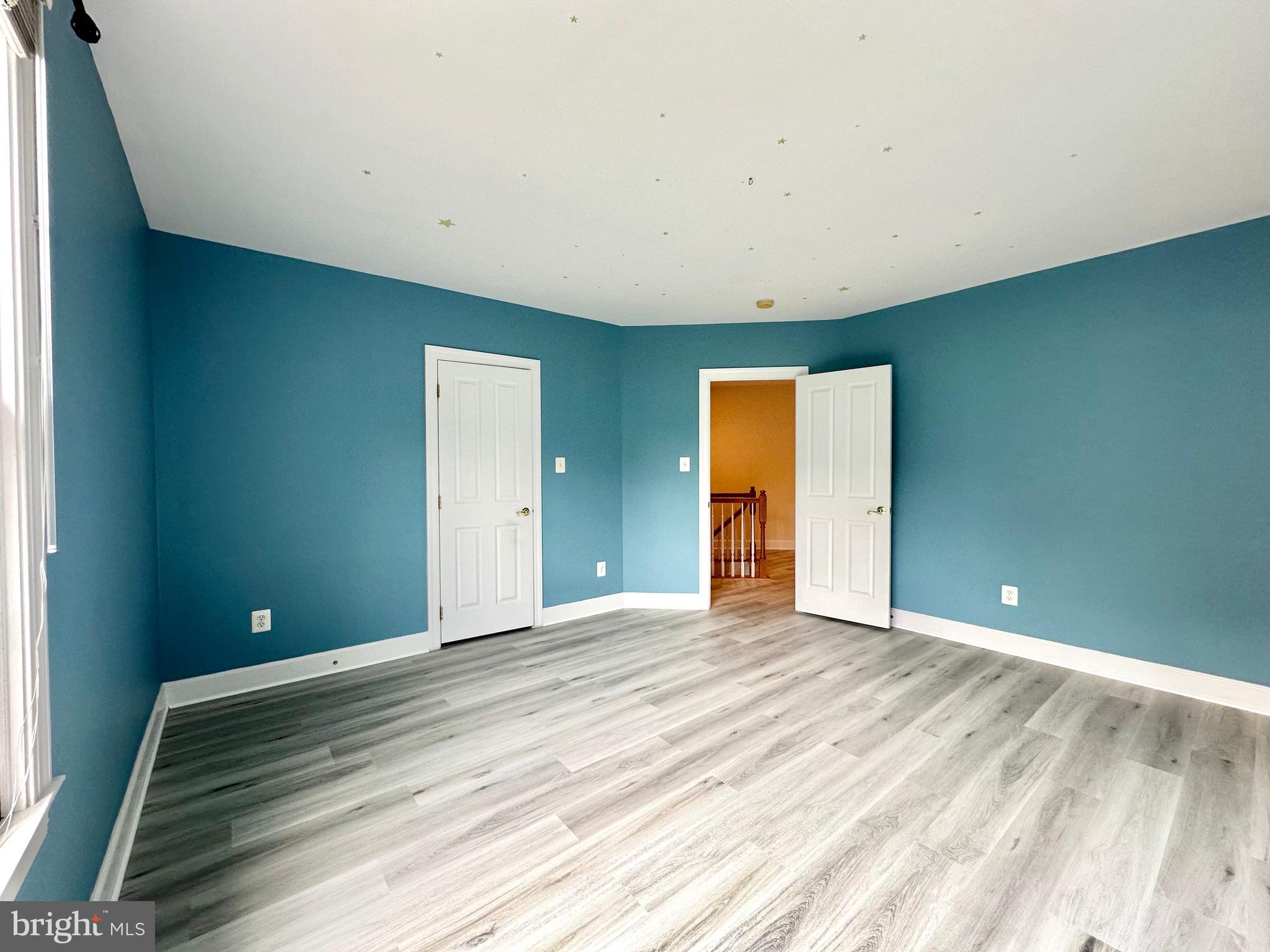 1460 Carrington Ridge Lane Vienna, VA 22182 - Photo 52 of 74 a view of an empty room with wooden floor and a window