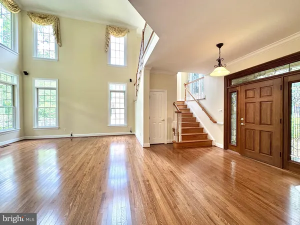 a view of an entryway with wooden floor door and windows