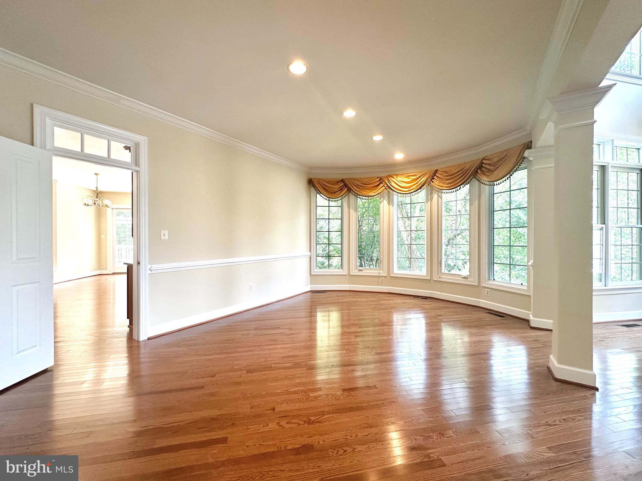 1460 Carrington Ridge Lane Vienna, VA 22182 - Photo 10 of 74 a view of an empty room with wooden floor and a window