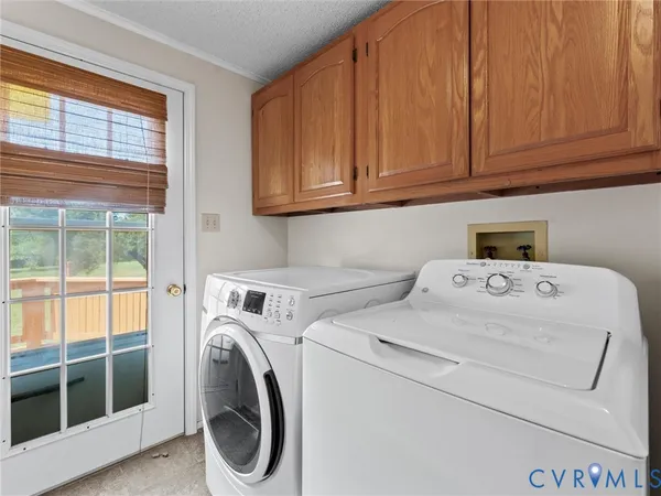 a kitchen with granite countertop a sink a stove a cabinets and a window