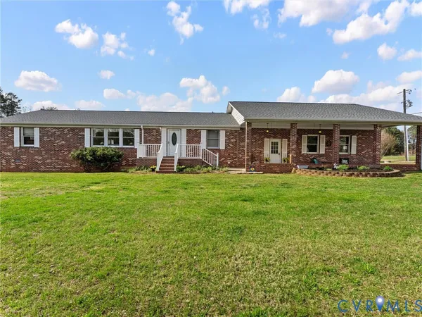 a front view of house with yard outdoor seating and barbeque oven