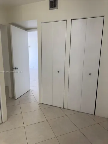 a view of an empty room and a window