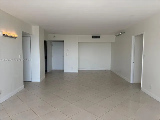 a kitchen with a refrigerator a sink and cabinets