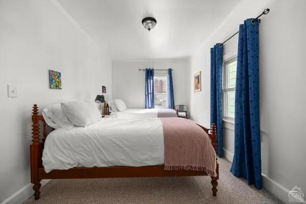 a bedroom with a bed and a mirror