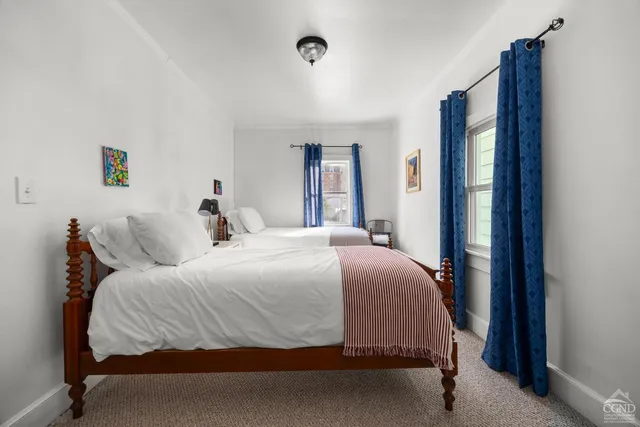 a bedroom with a bed and a mirror