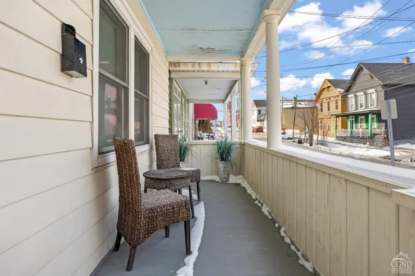 a view of a chair and tables in the balcony