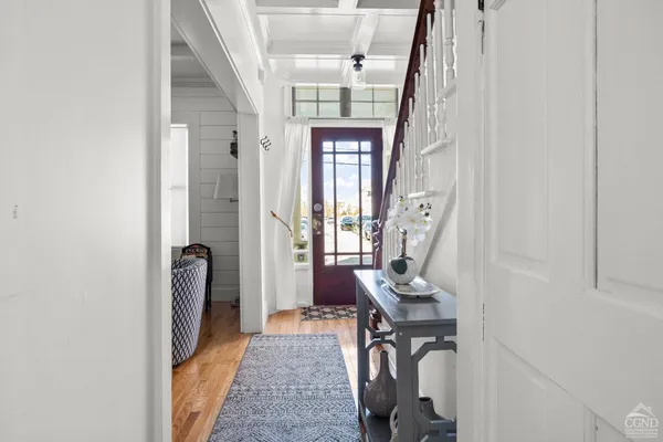 a view of a hallway with windows and closet