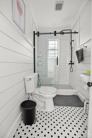a bathroom with a toilet a sink and a shower