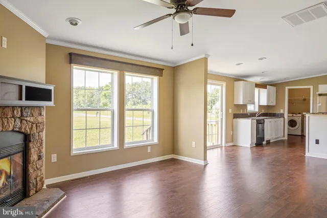 a view of an empty room with a fireplace and a window