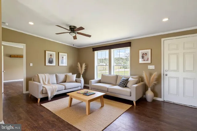 a living room with furniture a lamp and a table