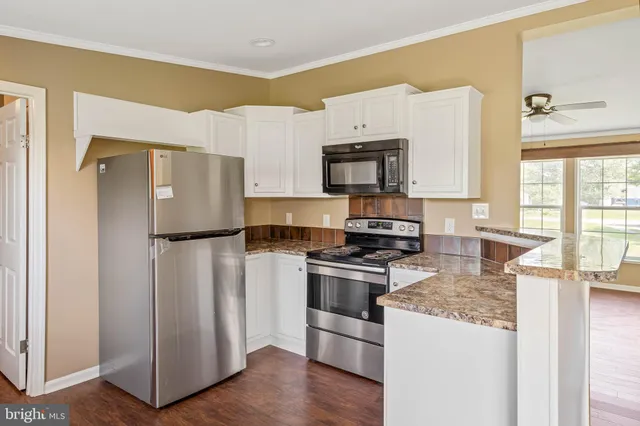a kitchen with a refrigerator sink and stove