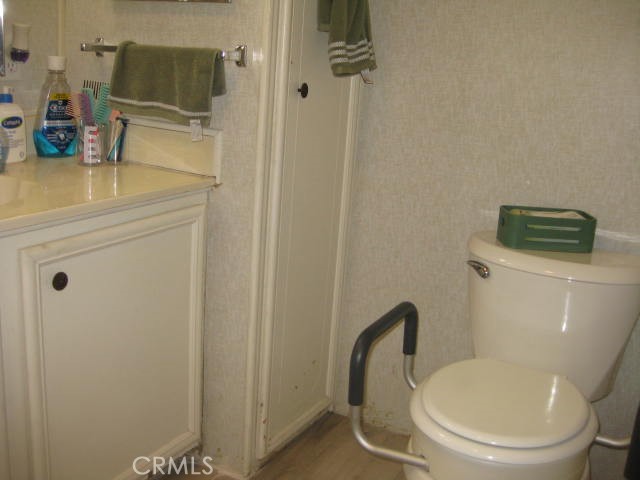 701 Montara Road, Unit 243 Barstow, CA 92311 - Photo 14 of 15 a bathroom with a toilet and a sink