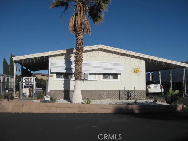 701 Montara Road, Unit 243 Barstow, CA 92311 - Photo 2 of 15 a front view of a house with garden