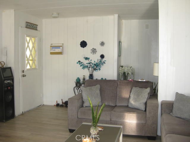 701 Montara Road, Unit 243 Barstow, CA 92311 - Photo 3 of 15 a living room with furniture and a potted plant