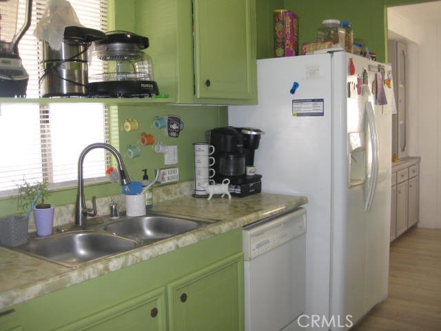 701 Montara Road, Unit 243 Barstow, CA 92311 - Photo 5 of 15 a kitchen with a refrigerator and a sink