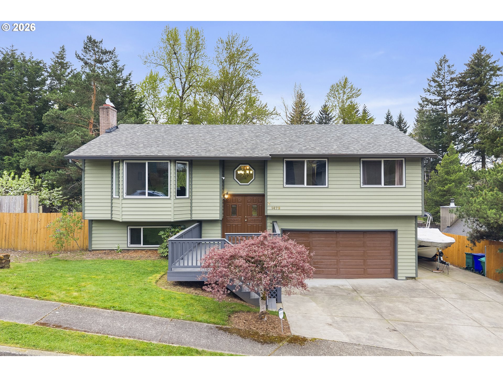 1472 Southwest 14th Street Gresham, OR 97080 - Photo 1 of 40 a front view of a house with a garden and plants