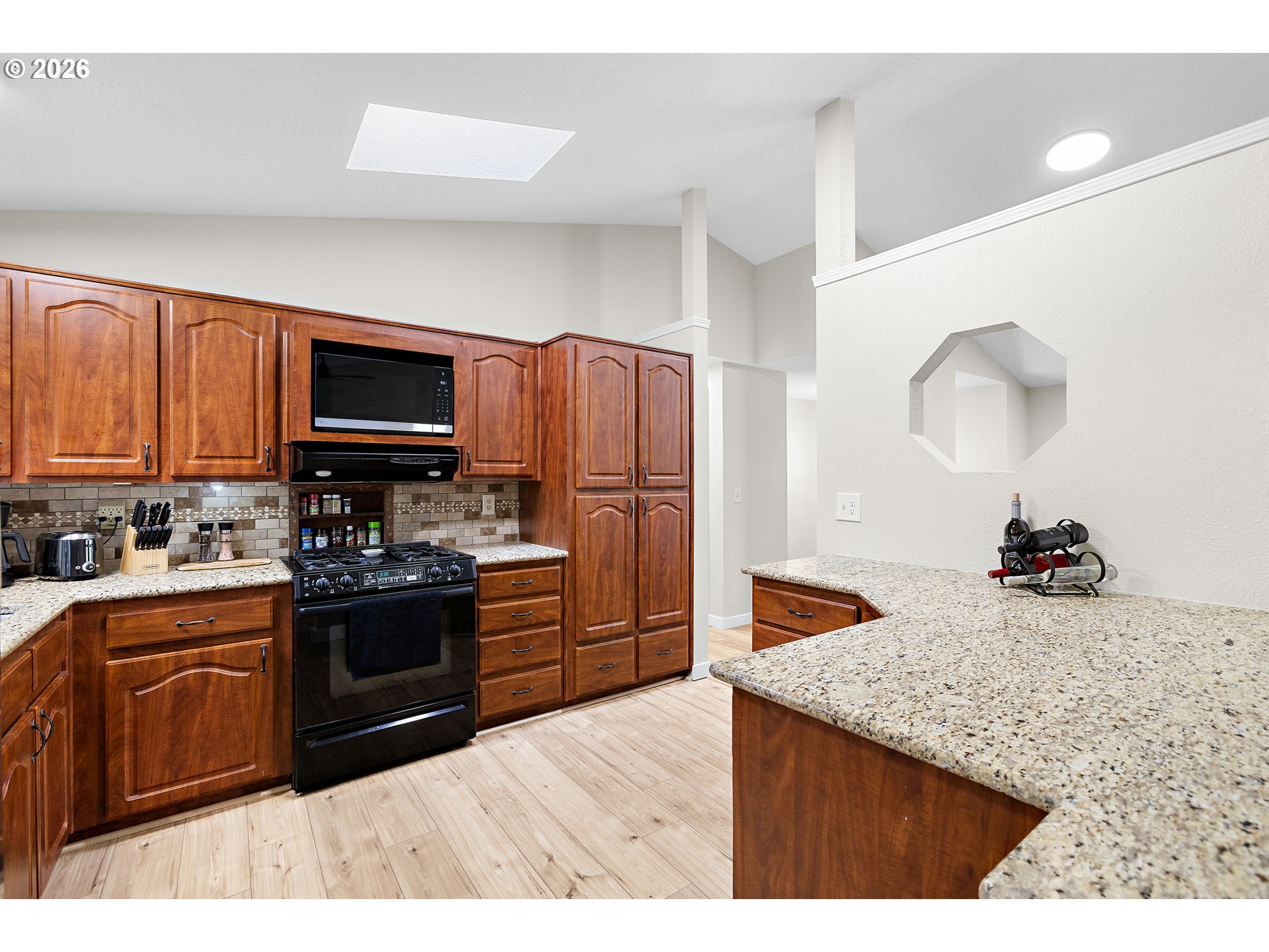 1472 Southwest 14th Street Gresham, OR 97080 - Photo 11 of 40 a kitchen with granite countertop a stove top oven and refrigerator