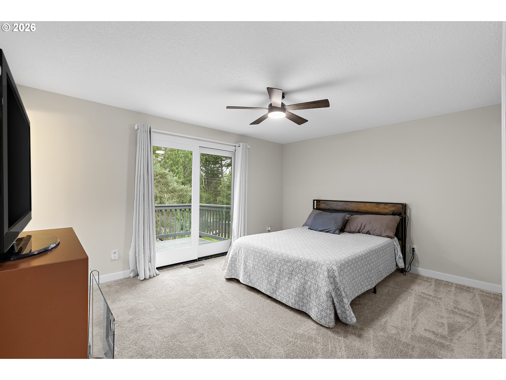 1472 Southwest 14th Street Gresham, OR 97080 - Photo 12 of 40 a bedroom with a large bed and a tv