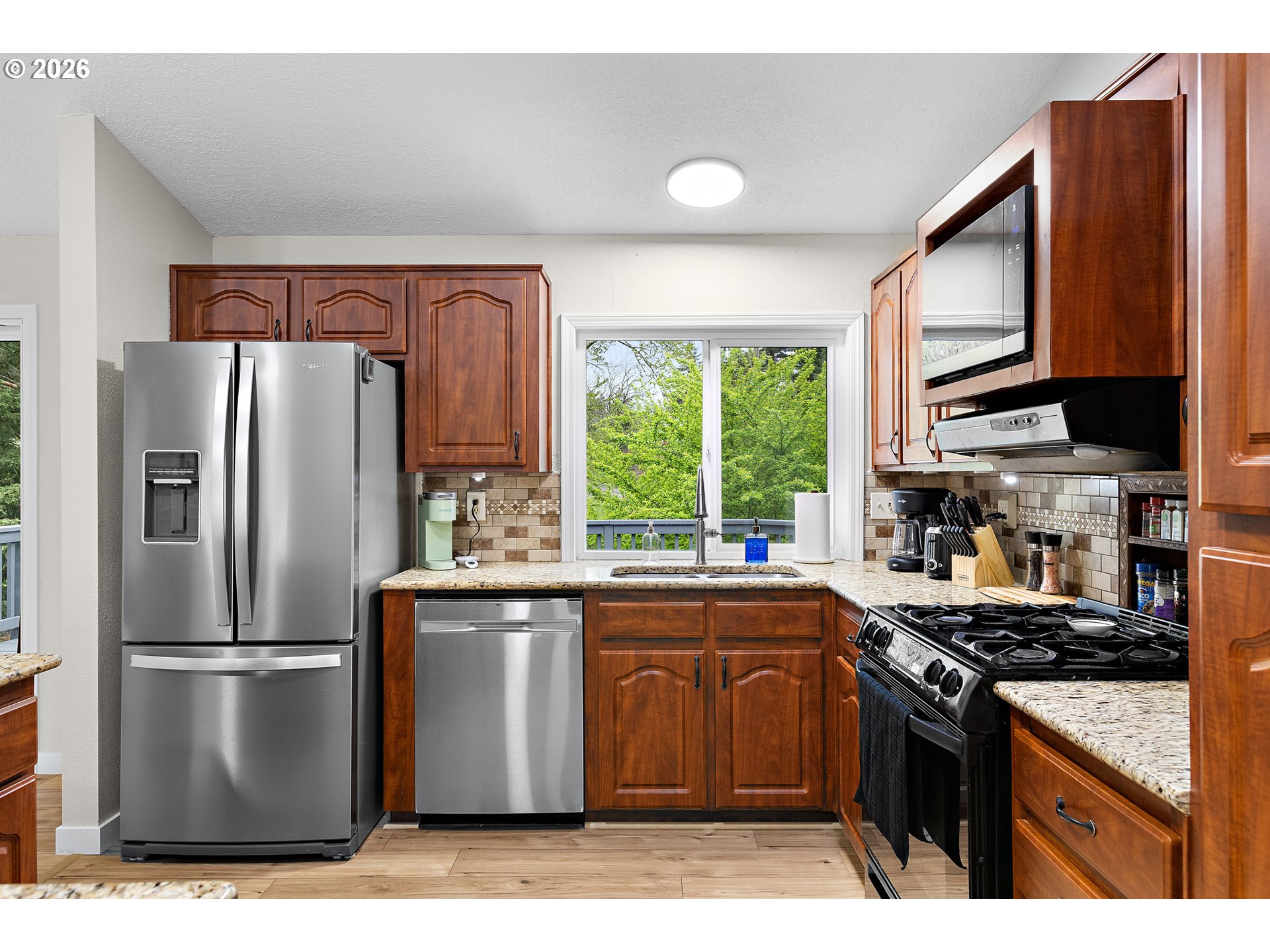 1472 Southwest 14th Street Gresham, OR 97080 - Photo 5 of 40 a kitchen with stainless steel appliances granite countertop a stove refrigerator sink and dishwasher