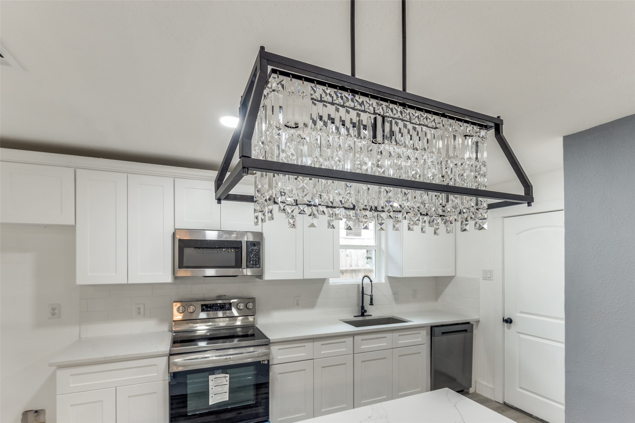 23115 Lestergate Drive Spring, TX 77373 - Photo 11 of 25 a kitchen with stainless steel appliances a sink dishwasher a refrigerator and cabinets with wooden floor