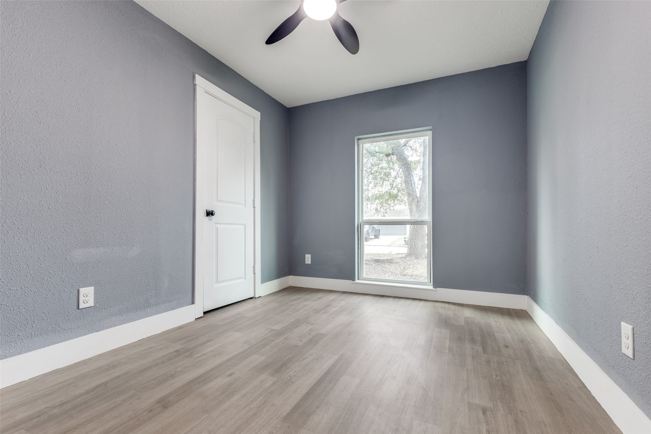 23115 Lestergate Drive Spring, TX 77373 - Photo 16 of 25 an empty room with wooden floor chandelier fan and windows