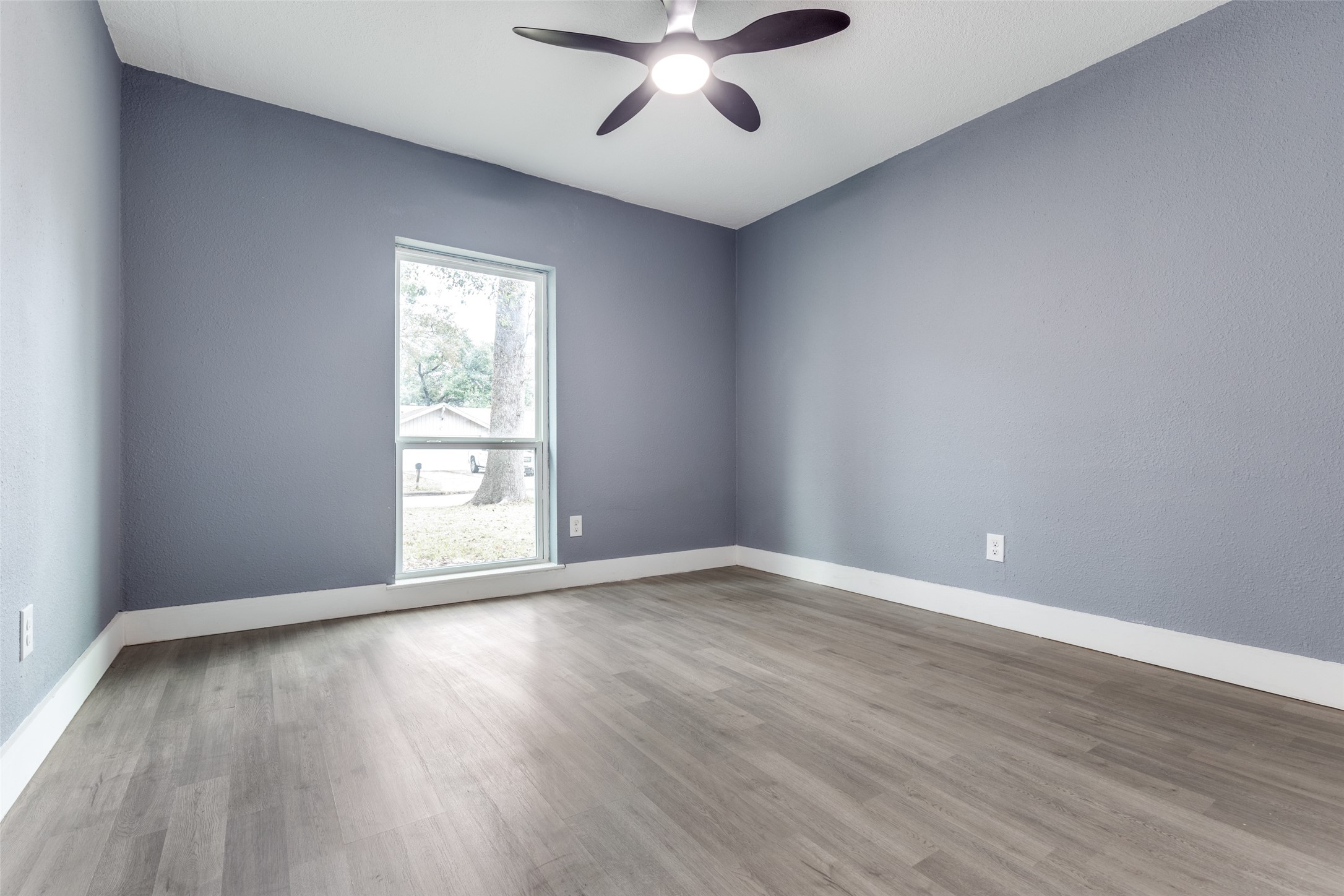 23115 Lestergate Drive Spring, TX 77373 - Photo 17 of 25 a view of an empty room with wooden floor and a window
