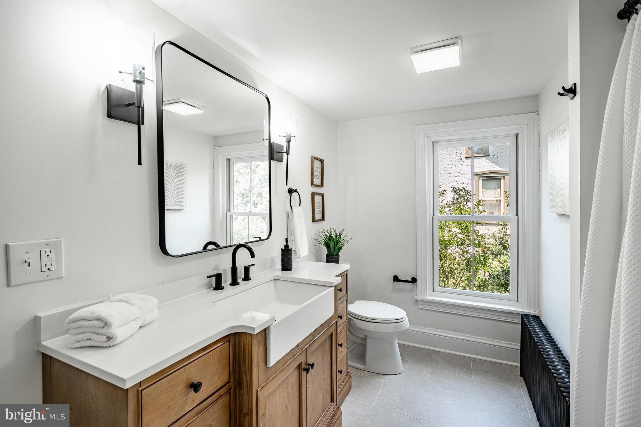 3661 St Peters Road Elverson, PA 19520 - Photo 24 of 36 a bathroom with a granite countertop sink toilet and a mirror