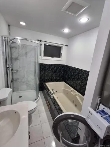 a bathroom with a toilet a sink and bathtub