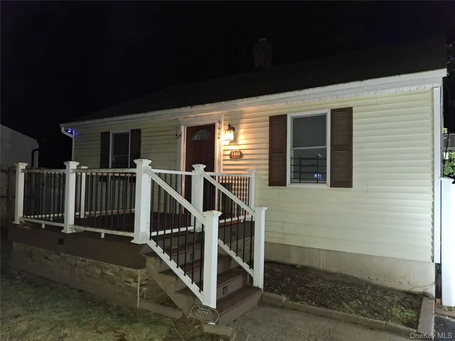 a view of deck house with wooden floor and a fence
