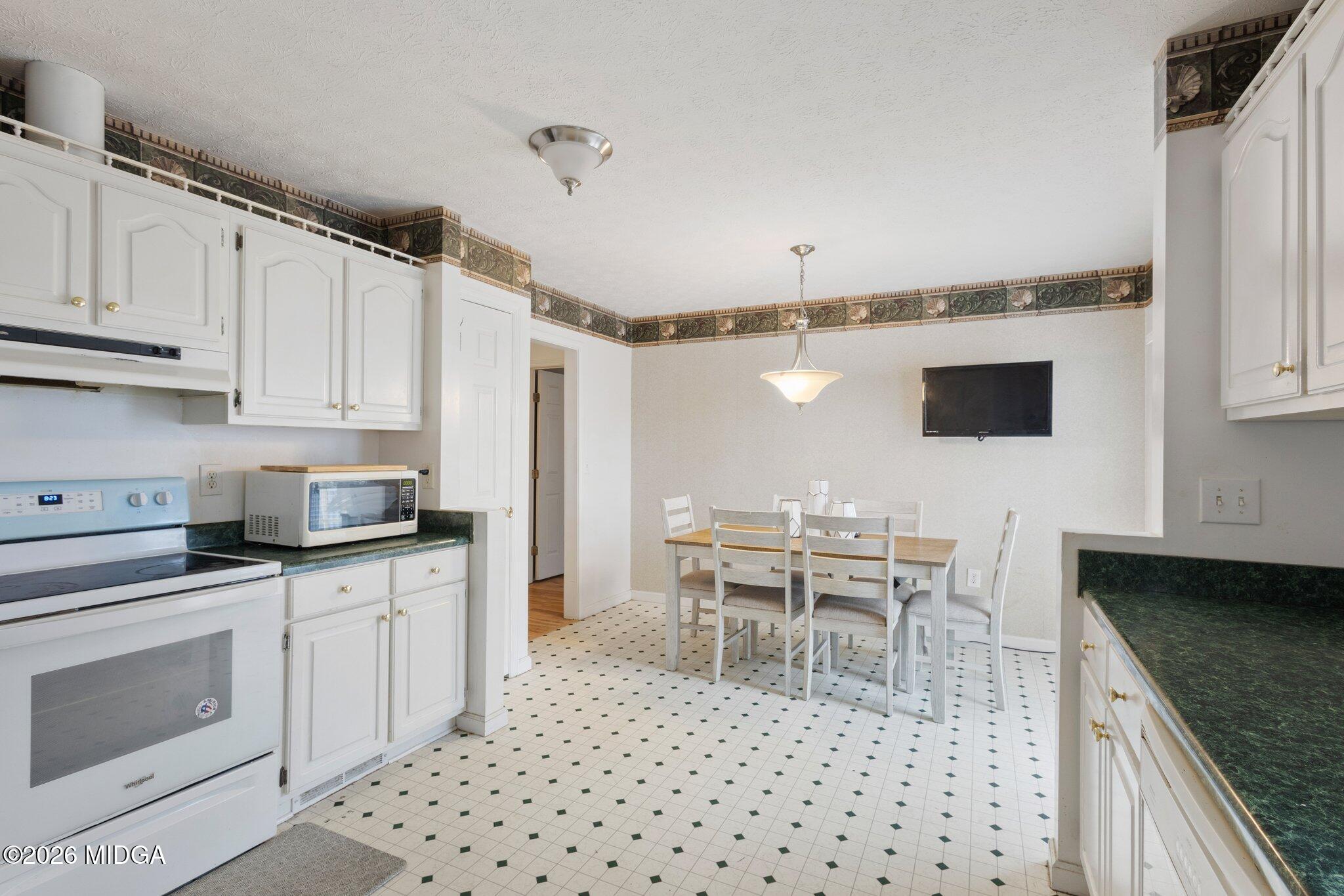 227 Dusty Lane Macon, GA 31211 - Photo 15 of 21 a kitchen with granite countertop a sink appliances cabinets and counter space