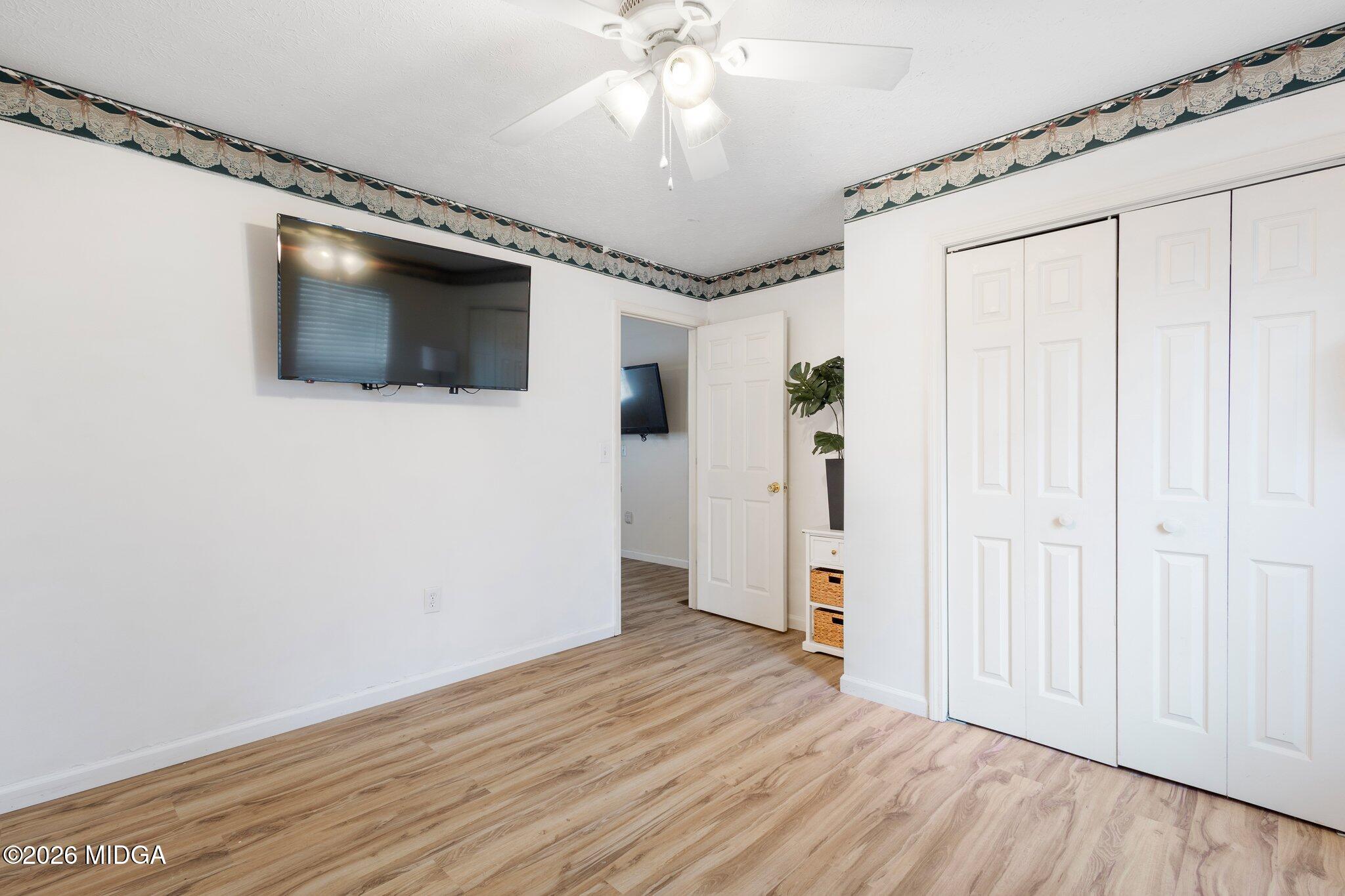 227 Dusty Lane Macon, GA 31211 - Photo 8 of 21 a view of a livingroom with wooden floor and a ceiling fan