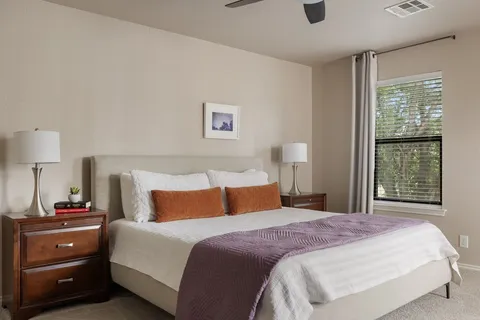 a bed room with a bed and a window