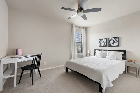 a bedroom with a large bed and a window