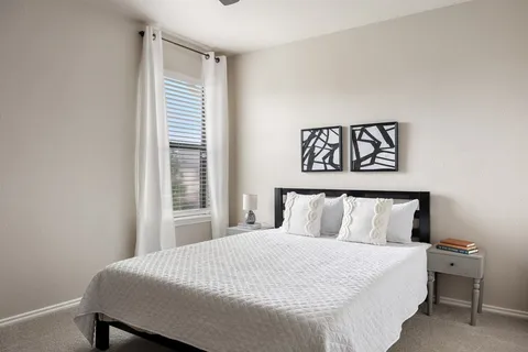 a bedroom with a bed and a ceiling fan