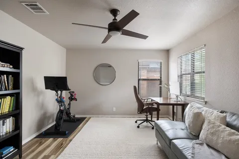 a living room with a couch and a book shelf