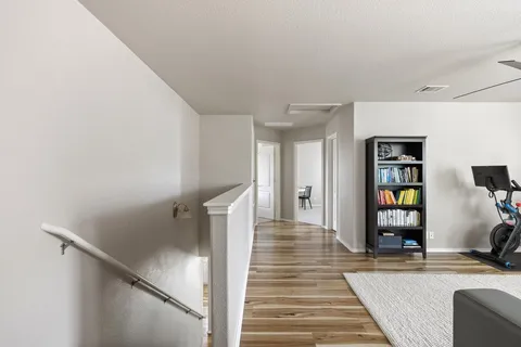 a bedroom with a large bed and a painting on the wall