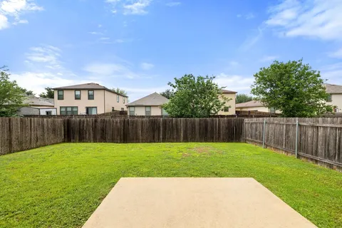a view of a house with a yard and deck