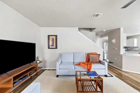 a living room with furniture and a flat screen tv
