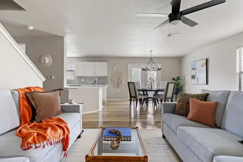 a living room with furniture a rug and a chandelier
